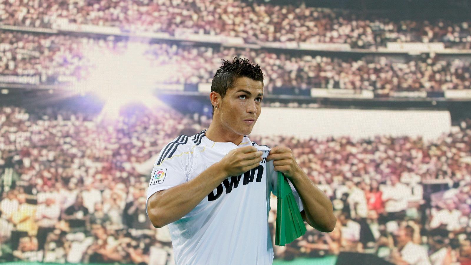 Real Madrid new soccer player Cristiano Ronaldo from Portugal kisses his new jersey during his presentation at the Santiago Bernabeu stadium in Madrid on Monday, July 6, 2009.